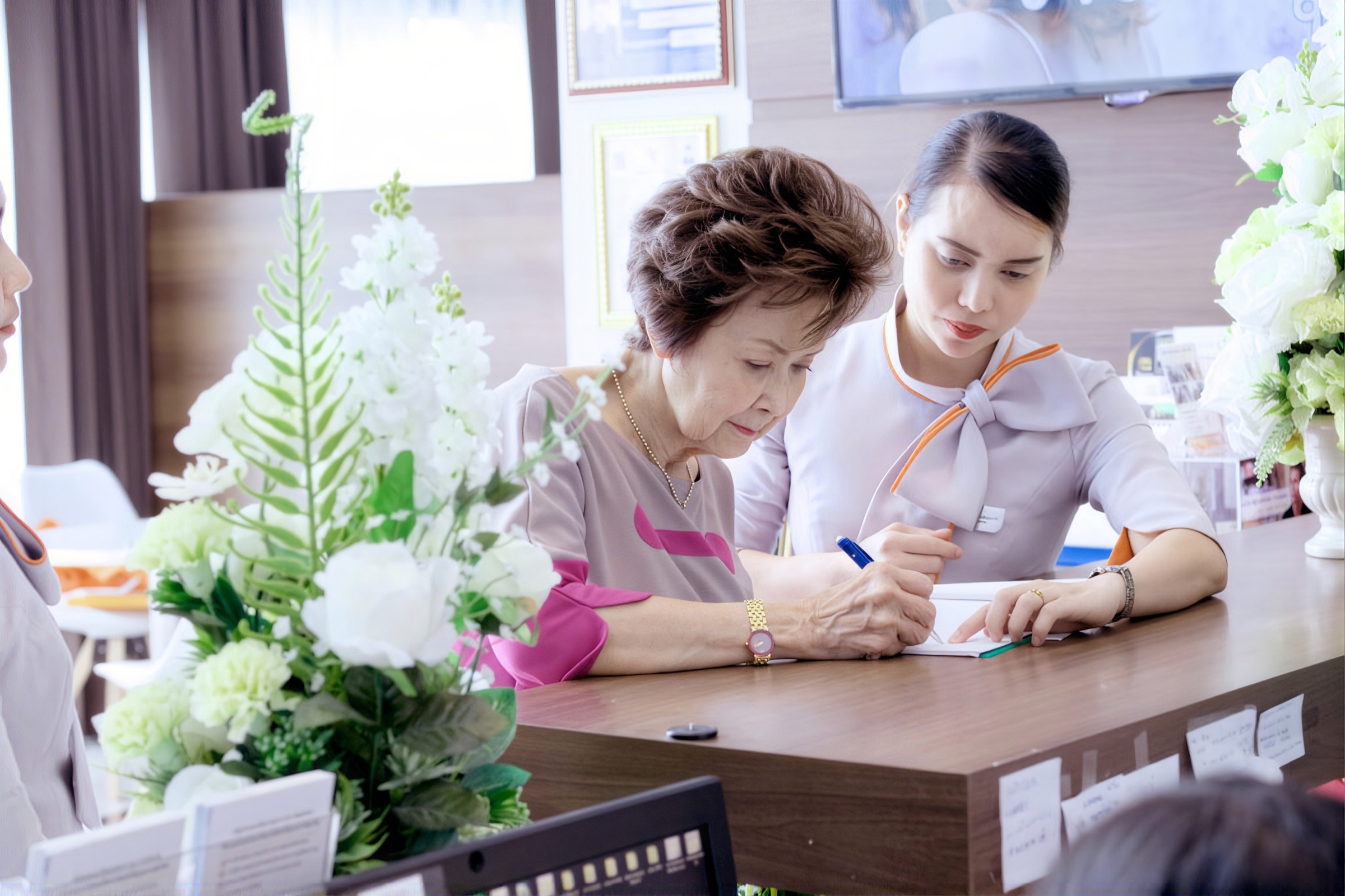 BAAC staff assisting a patient at the clinic reception